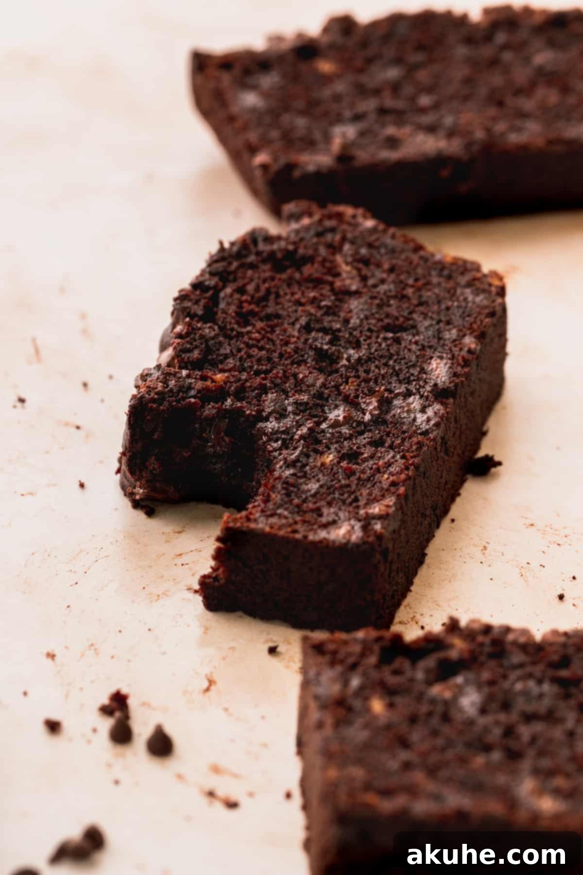 Decadent Double Chocolate Banana Bread 10 A delectable slice of double chocolate banana bread with a bite taken out, showing its moist interior and rich chocolate.