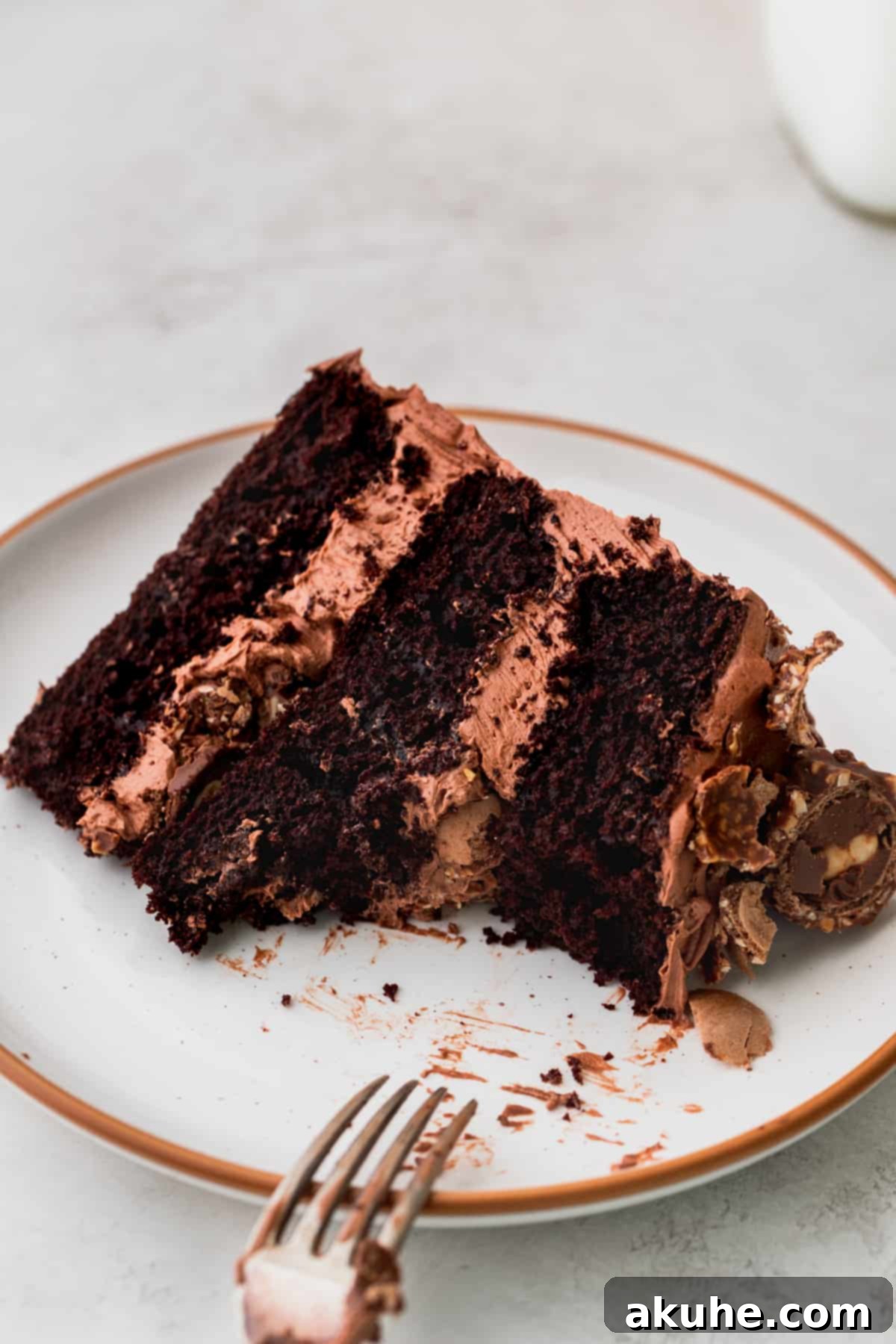 One slice of Ferrero Rocher cake on a plate with a fork.