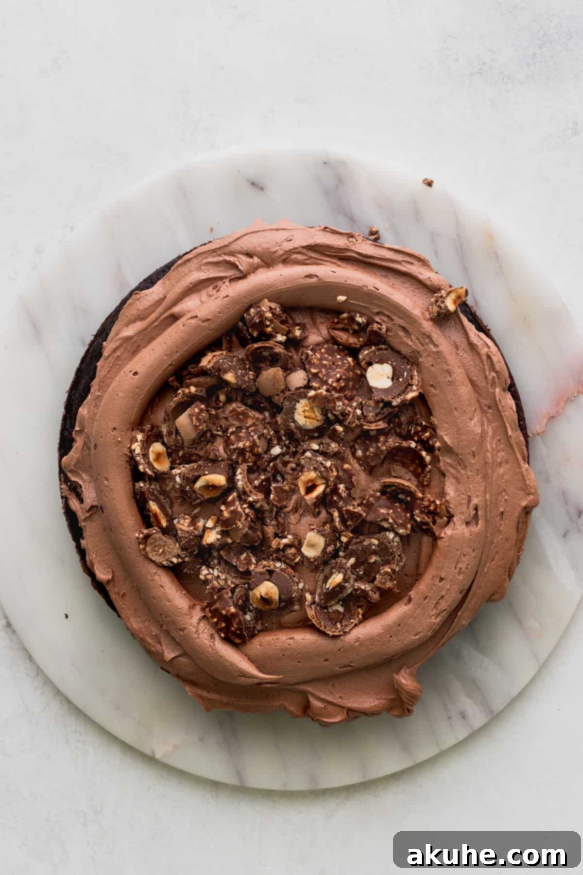 Chopped Ferrero Rocher on top of cake.