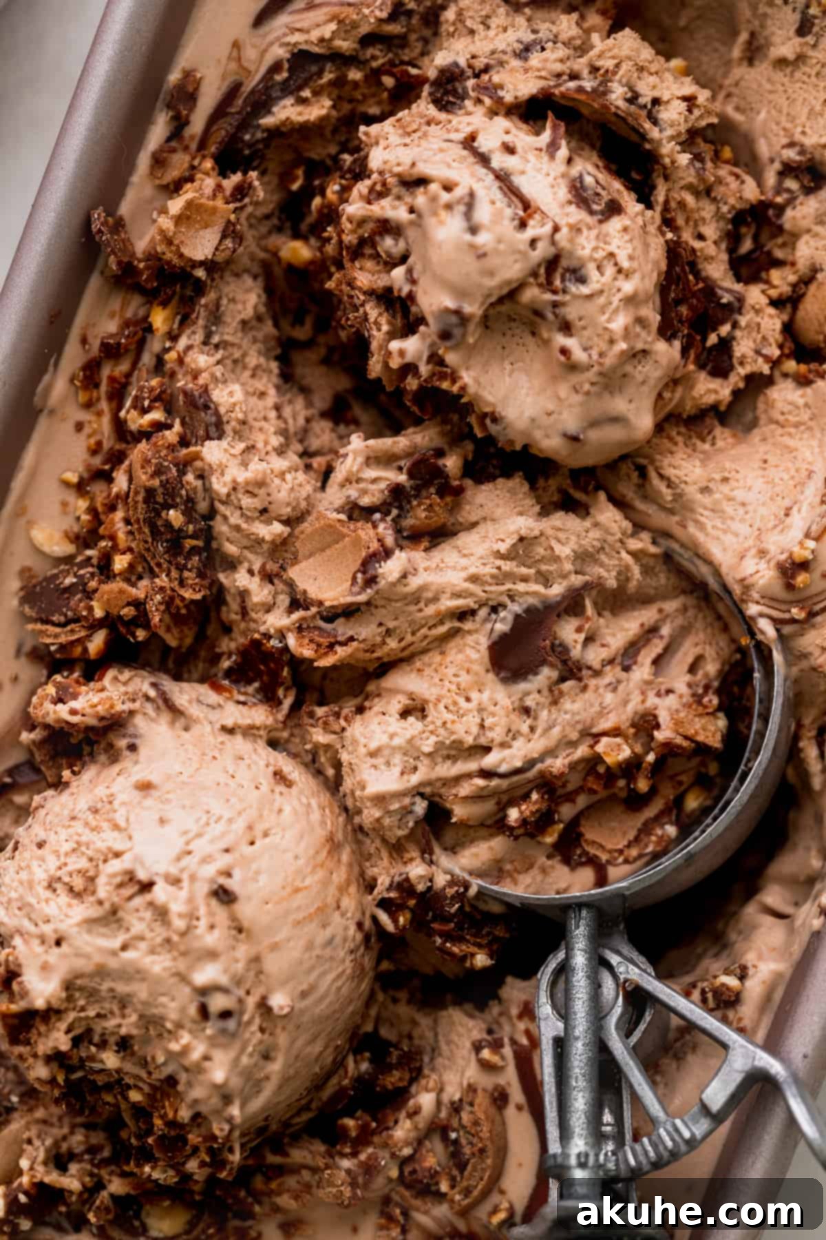 Close-up of creamy Nutella ice cream in a metal tin, ready for serving.