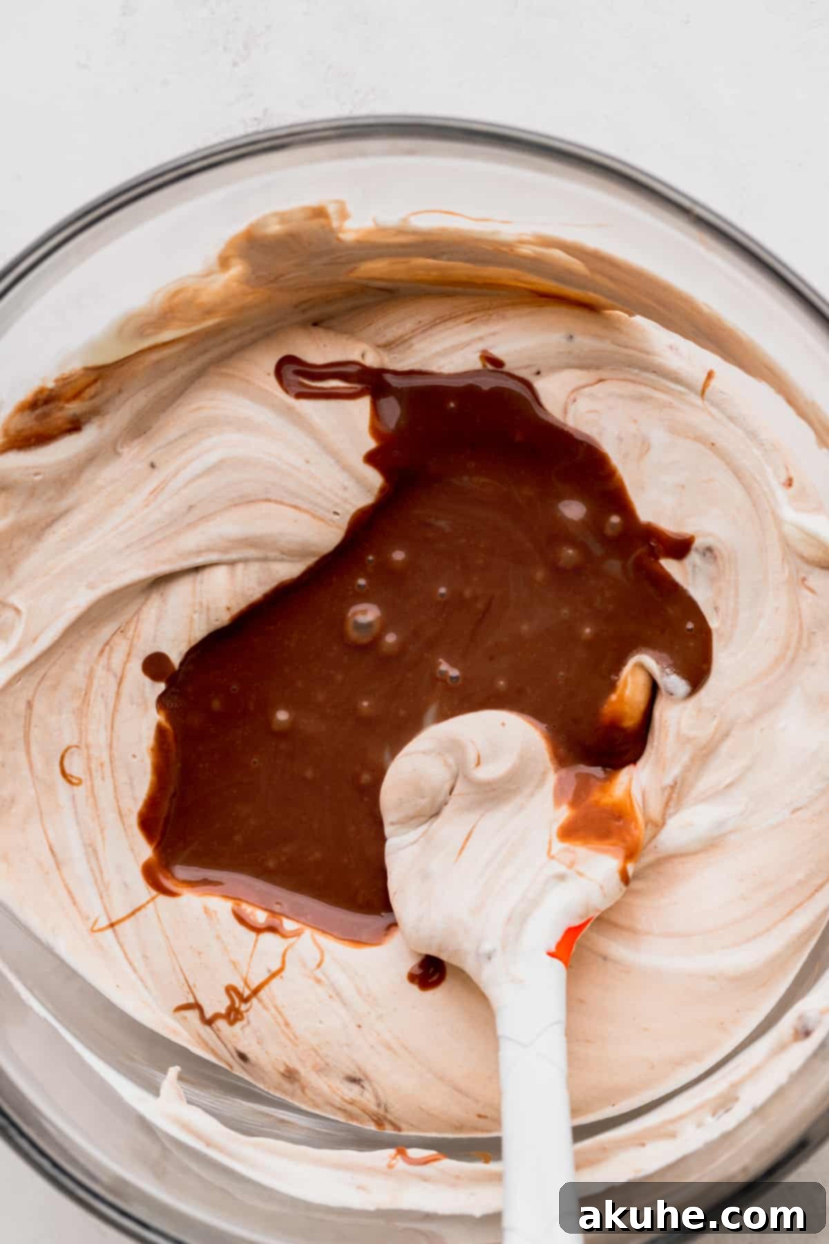 Creamy Nutella ice cream batter in a pristine glass bowl, ready for layering.