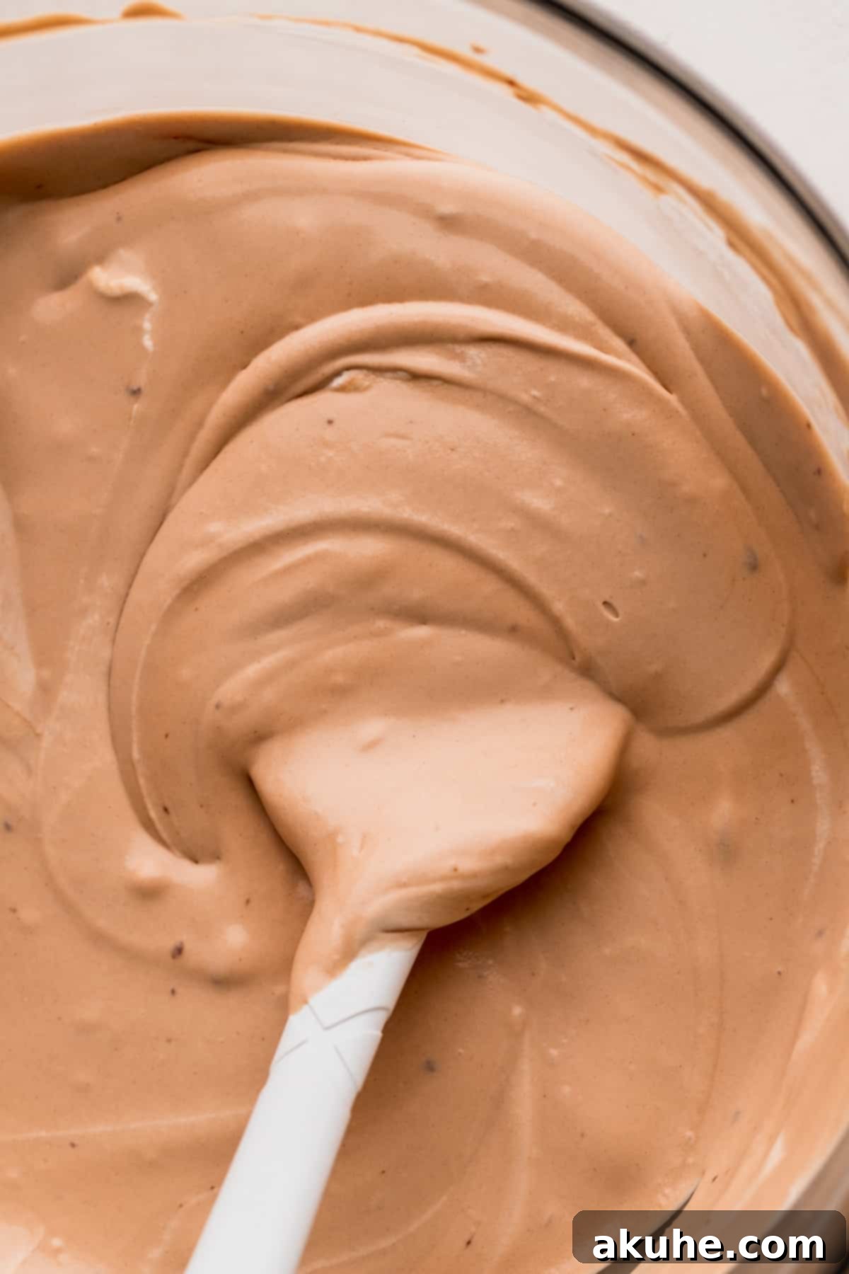 Close-up of the rich, smooth ice cream mixture in a glass bowl.