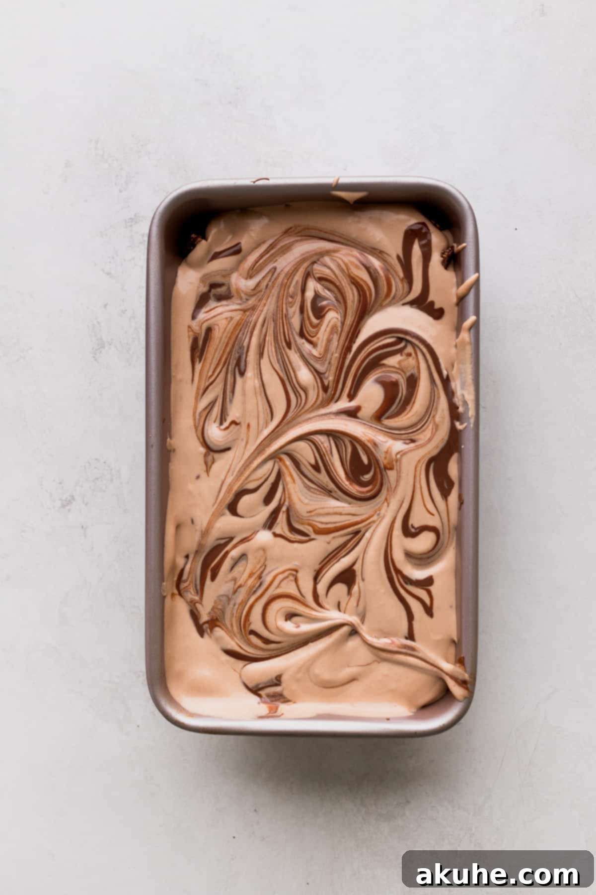 Artfully swirled Nutella on top of the creamy ice cream mixture.