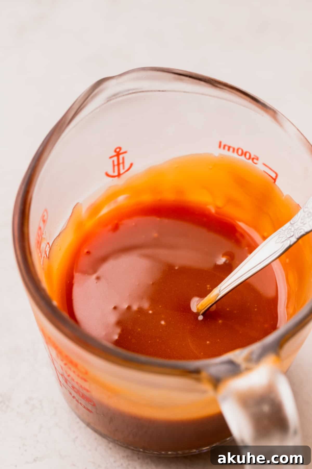 Homemade Salted Caramel Delights 3 Caramel in a glass measuring cup, showing its smooth, rich texture.