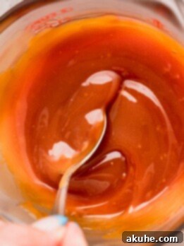 Homemade Salted Caramel Delights 10 Mixing homemade salted caramel in a glass container.