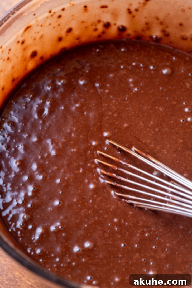 Decadent Triple Chocolate Cake 4 Chocolate cake batter in a glass bowl.