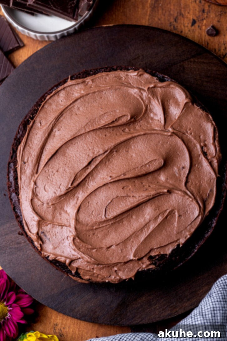 Decadent Triple Chocolate Cake 8 Frosting on top of cake.