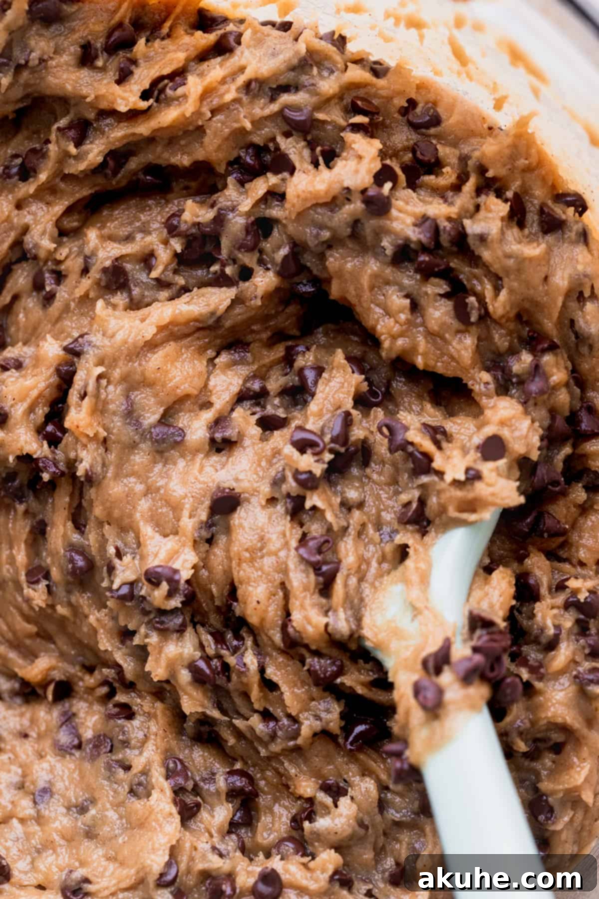 Close-up of fluffy, moist cookie dough in a glass bowl.