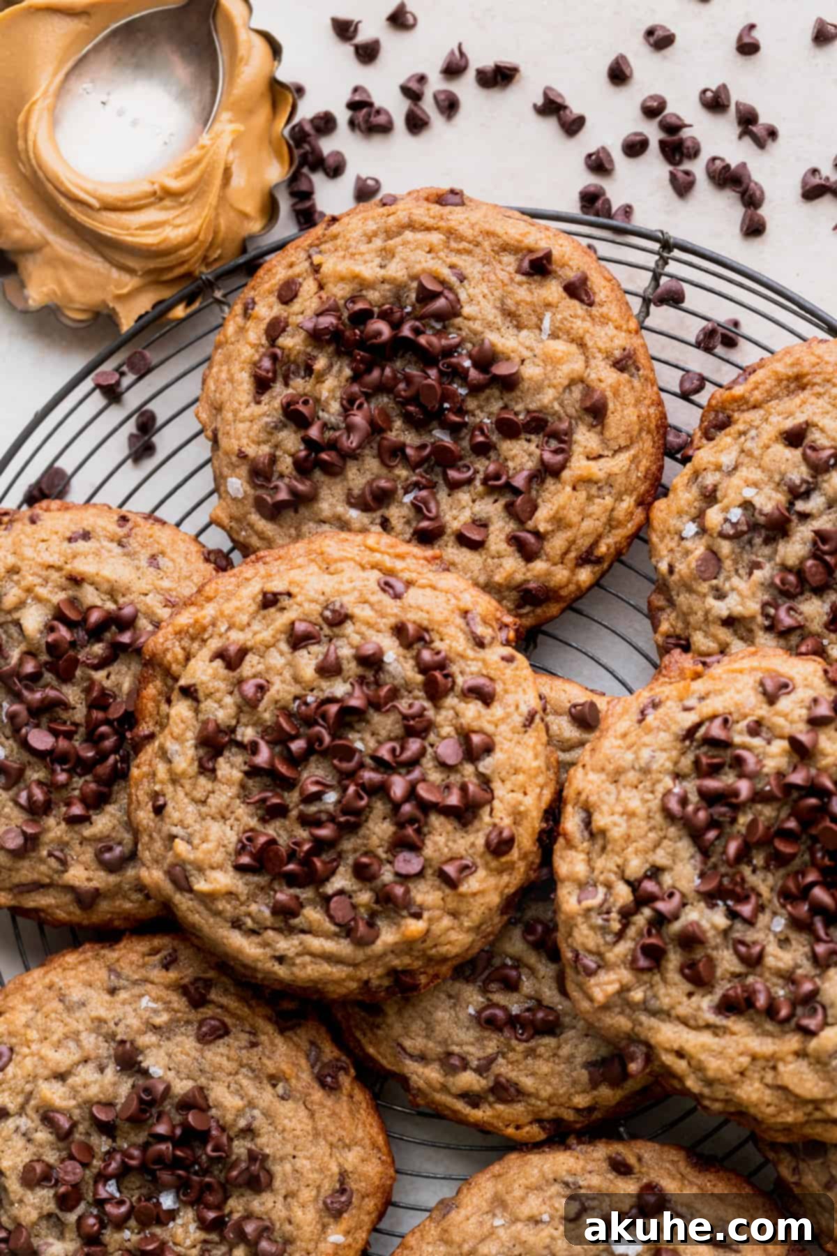 Stack of golden banana peanut butter cookies on a cooling rack, looking perfectly baked.