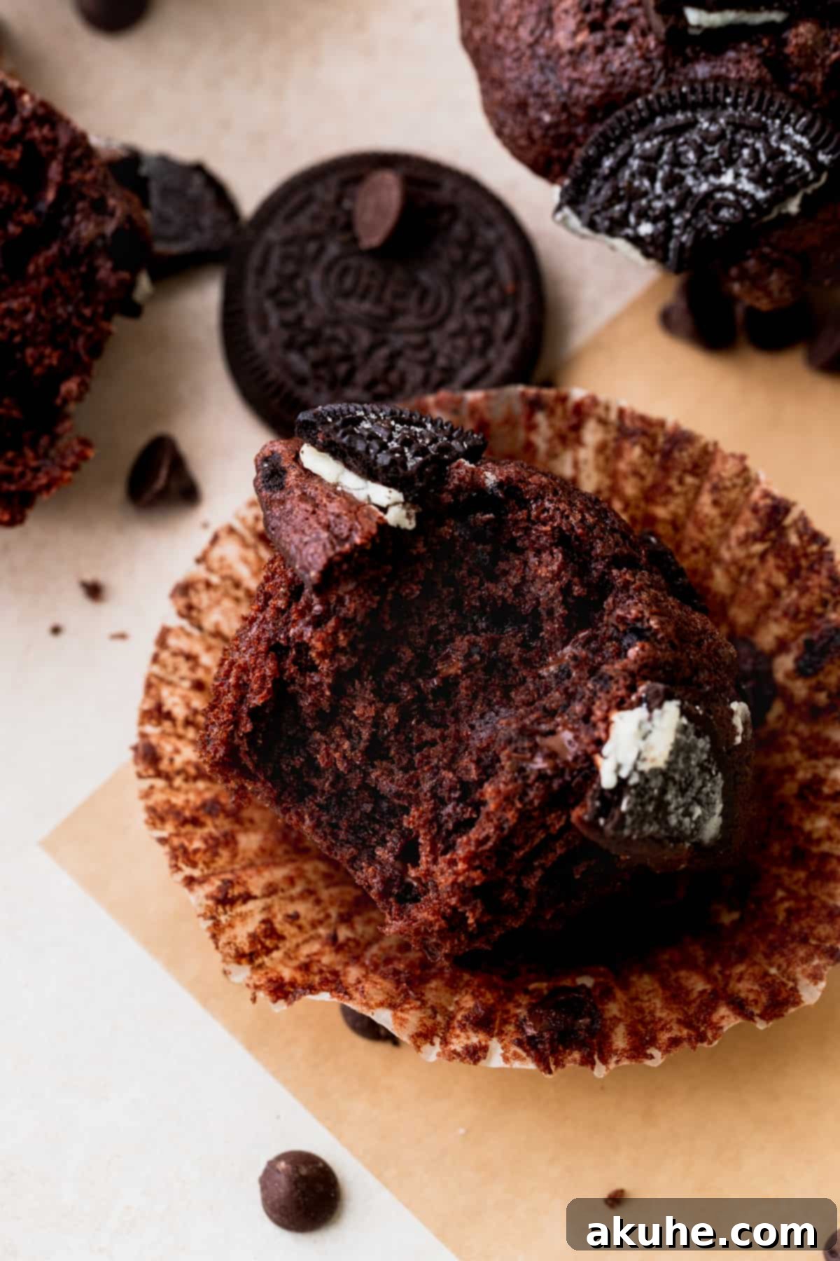 Decadent Oreo Delights 4 A close-up of a delicious Oreo muffin with a bite taken out, showing its fluffy interior and rich chocolate and Oreo pieces.