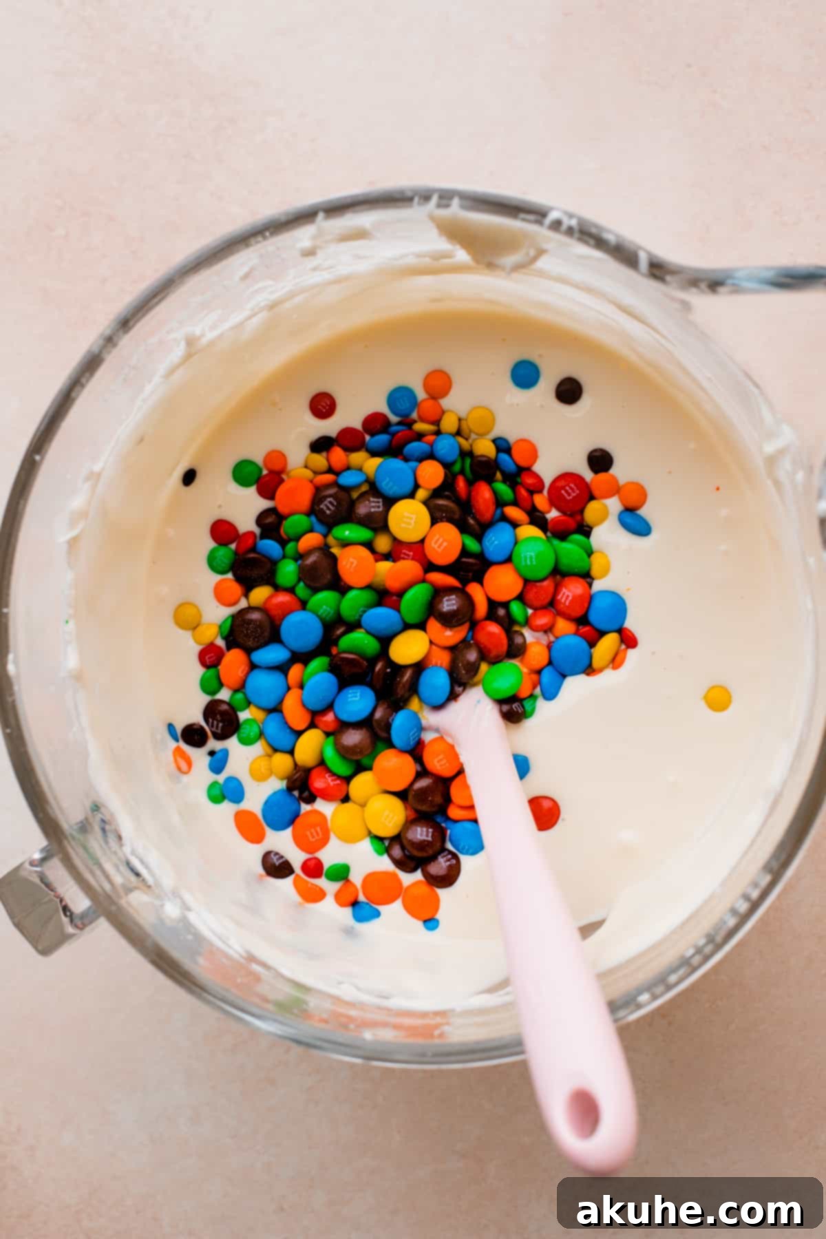 MM Cheesecake Bliss 7 M&Ms being folded into cheesecake batter.