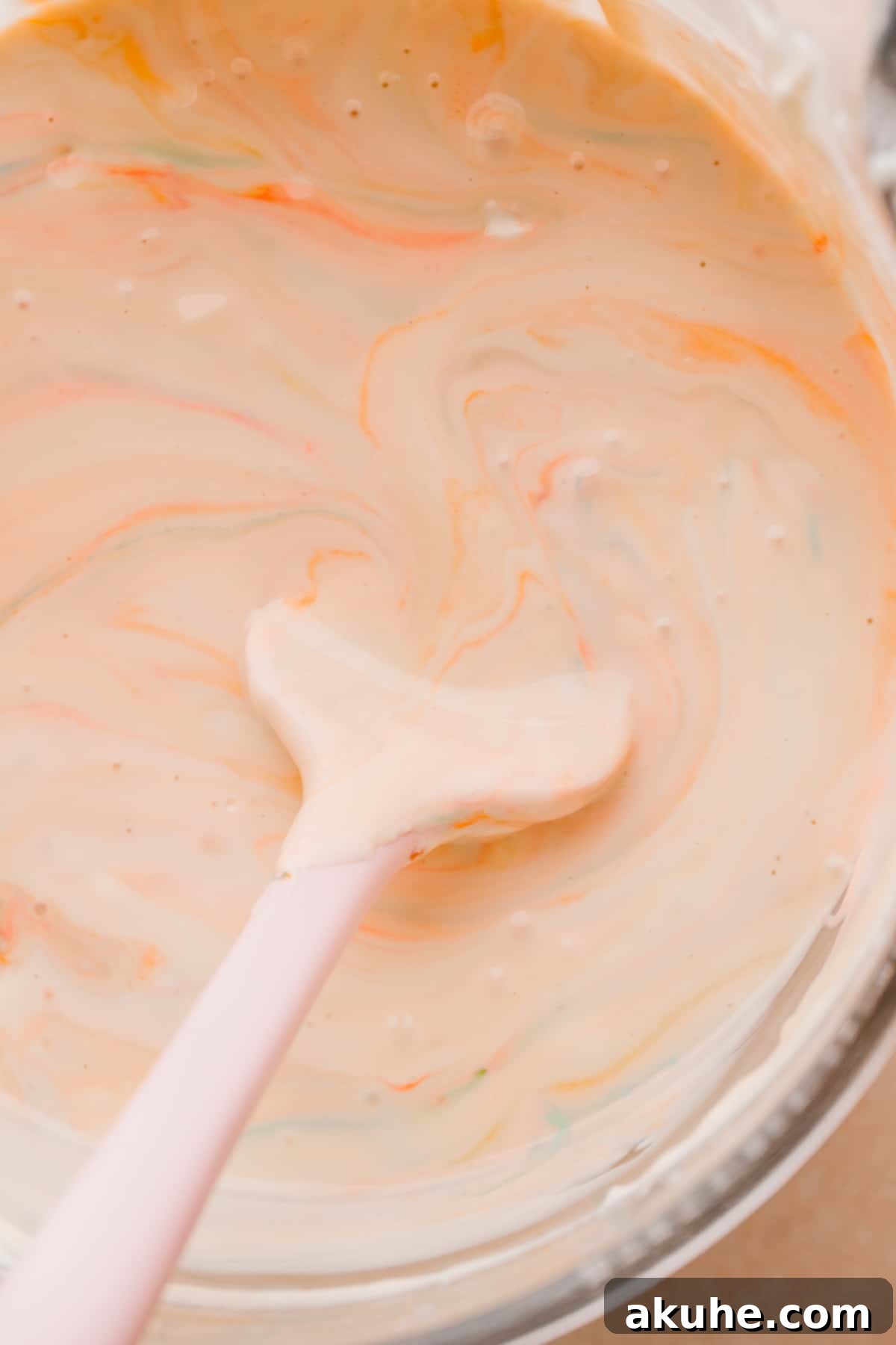 MM Cheesecake Bliss 8 Cheesecake batter with M&M's swirled in, ready for baking.