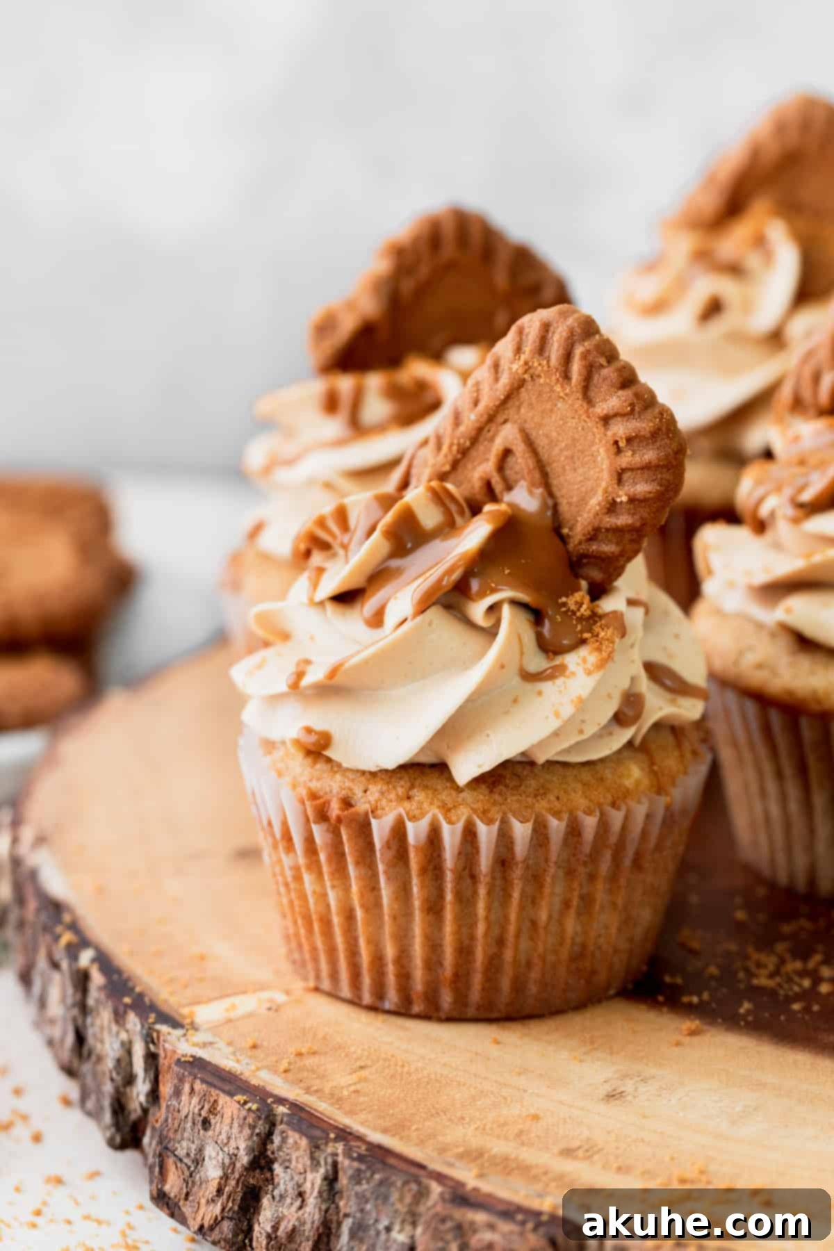 Irresistible Biscoff Cupcakes 11 A single, perfectly frosted Biscoff cupcake on a wooden surface, highlighting its detail.