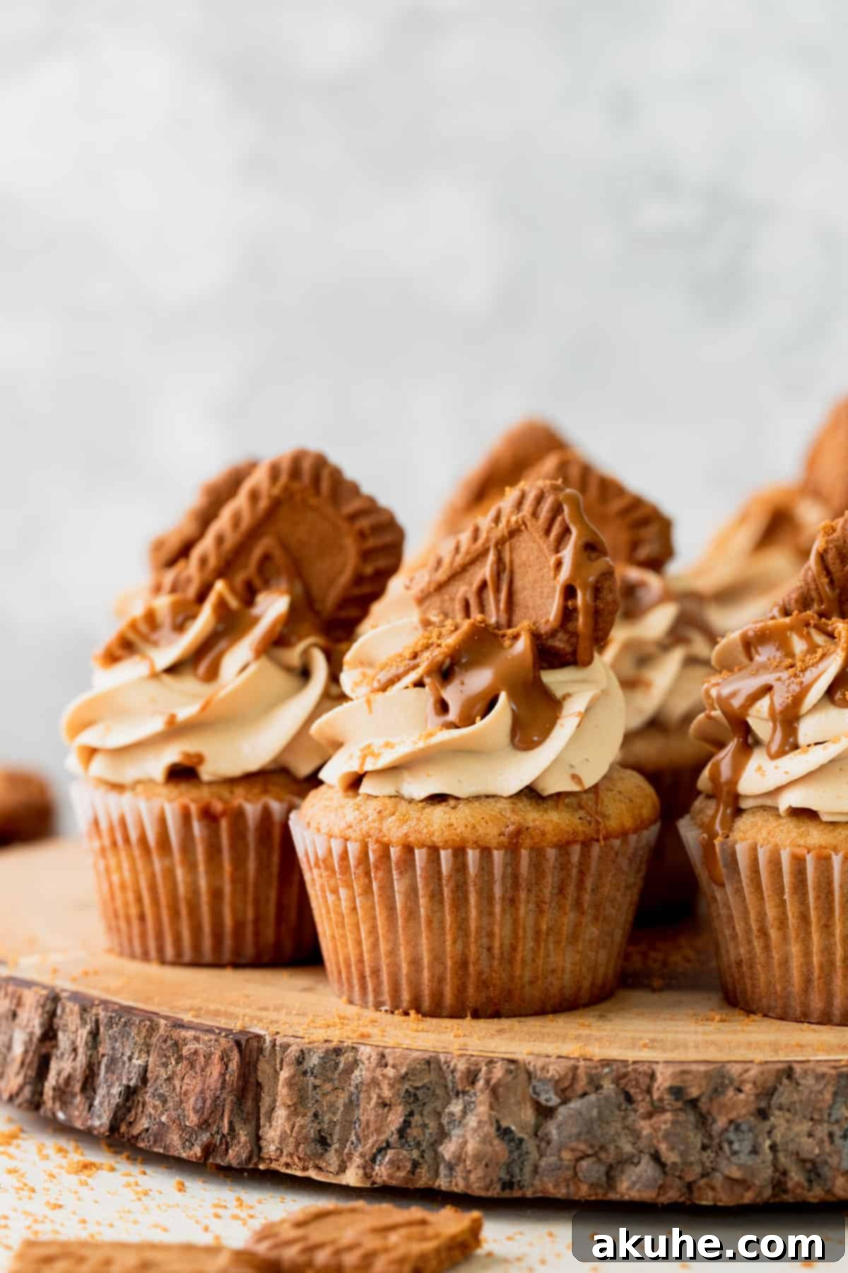 Irresistible Biscoff Cupcakes 3 Arrangement of Biscoff cupcakes on a rustic wooden board, showcasing their beautiful frosting.