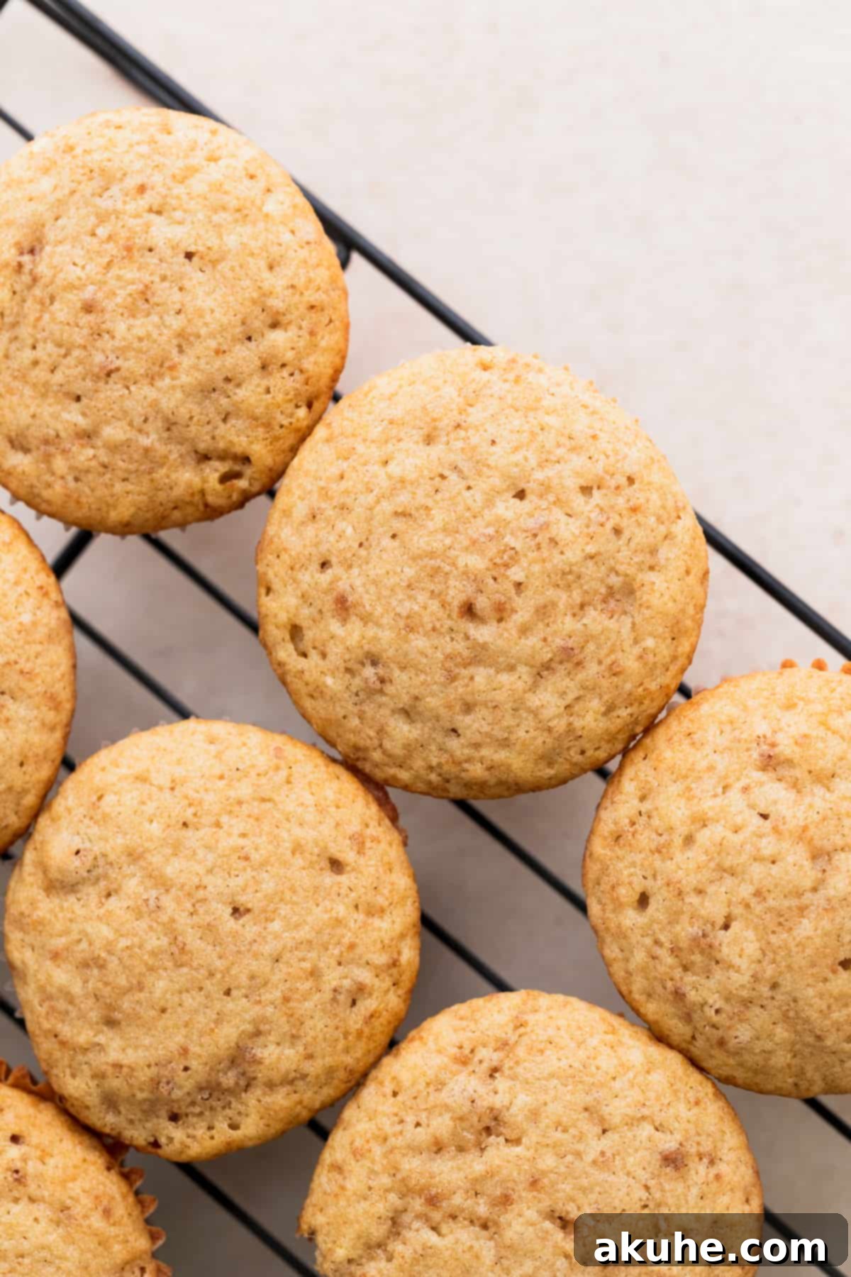 Irresistible Biscoff Cupcakes 8 Freshly baked Biscoff cupcakes cooling on a wire rack.
