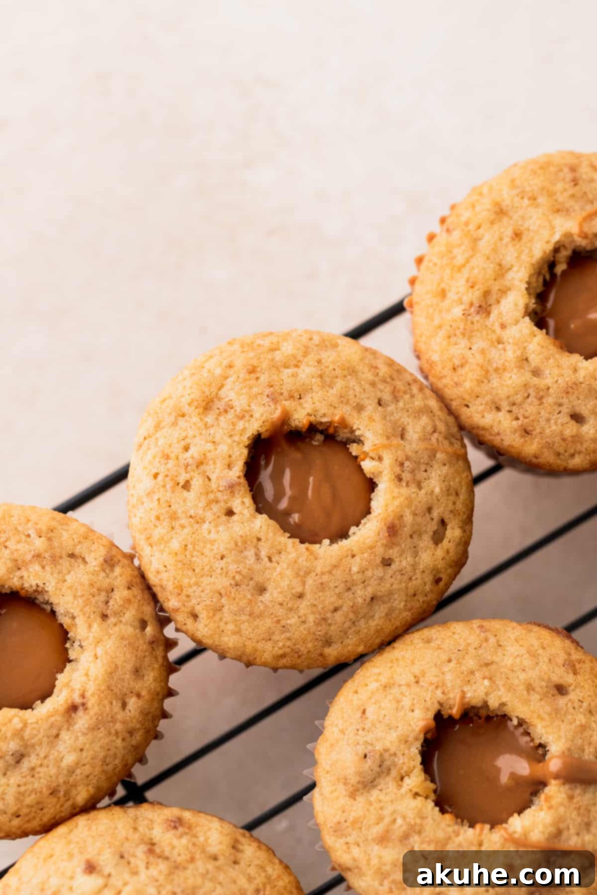 Irresistible Biscoff Cupcakes 9 Freshly filled Biscoff cupcakes, showcasing the melted cookie butter in the center.