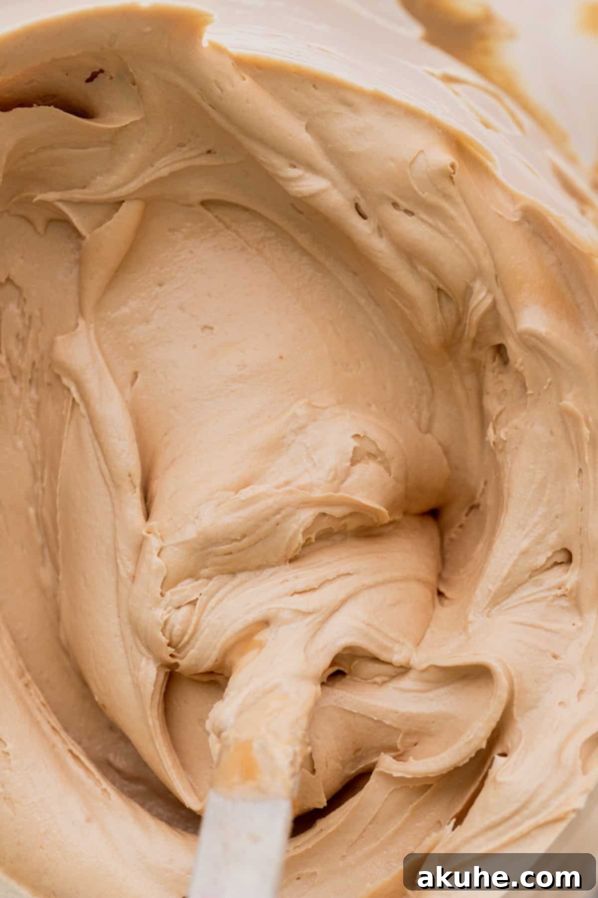 Irresistible Biscoff Cupcakes 10 Smooth and creamy Biscoff cookie butter frosting in a glass bowl.