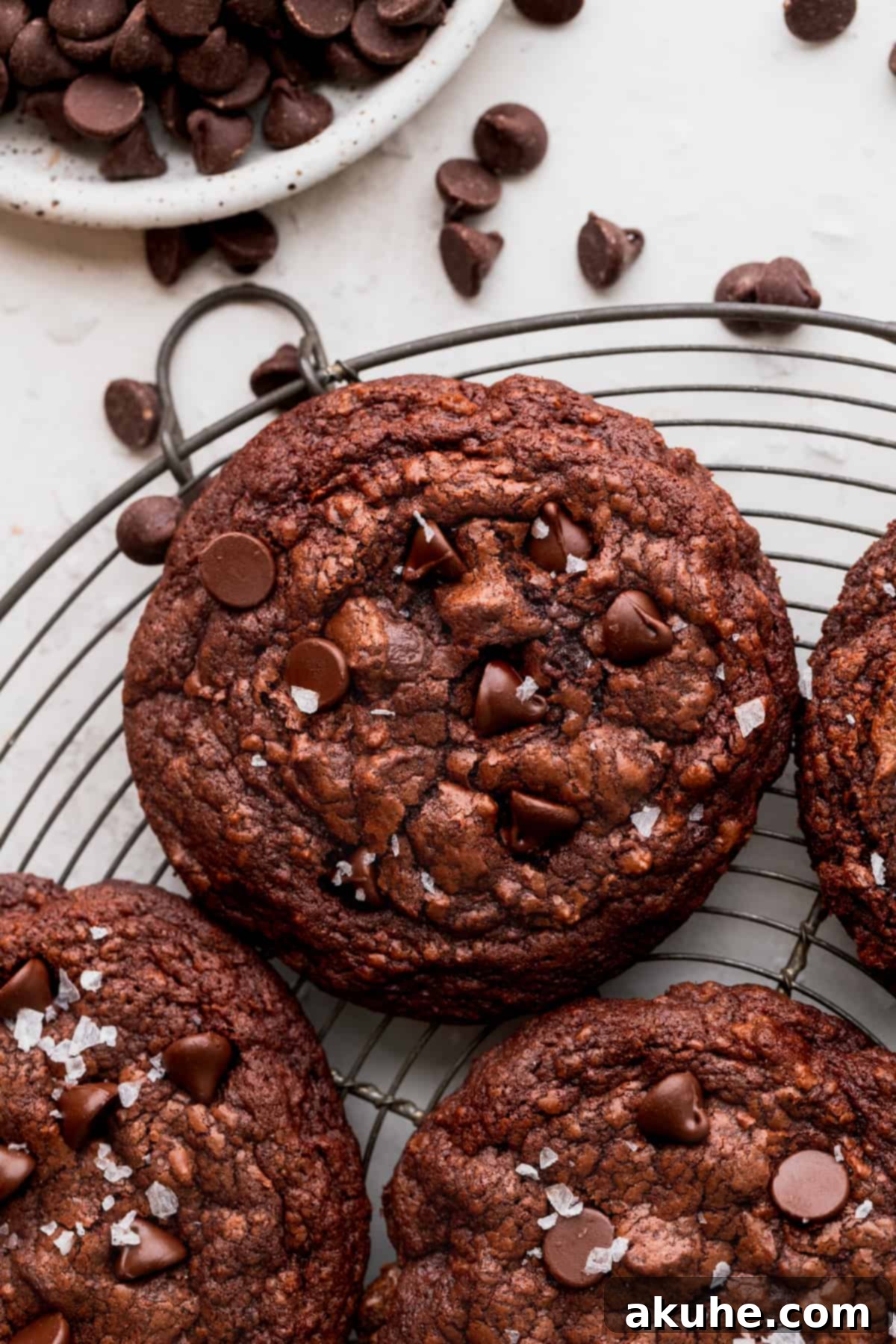 Ultimate Fudgy Crinkle Cookies 8 Freshly baked brownie crinkle cookies cooling on a wire rack, showcasing their beautiful crinkled tops.