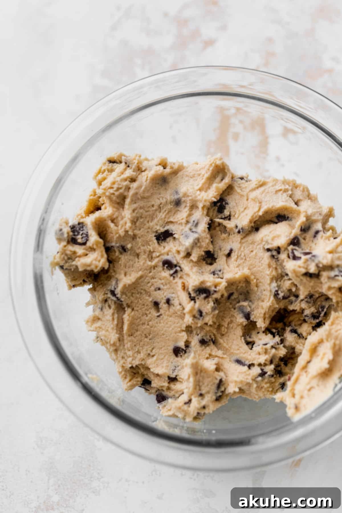 Decadent Cookie Dough Cheesecake Bars 5 Freshly mixed chocolate chip cookie dough in a glass bowl, ready to be shaped.