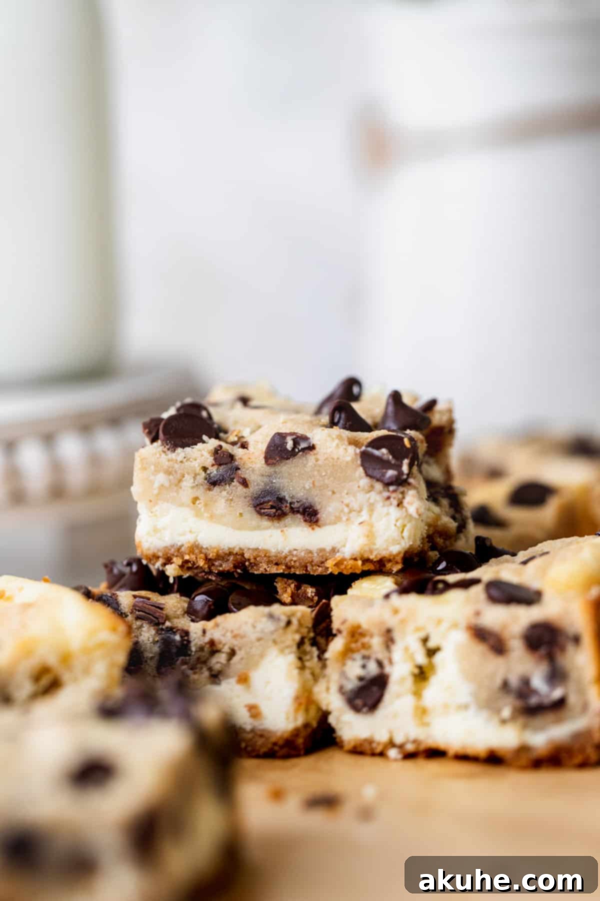 Decadent Cookie Dough Cheesecake Bars 10 A stack of three mouthwatering Cookie Dough Cheesecake Bars, beautifully presented and ready to be enjoyed.