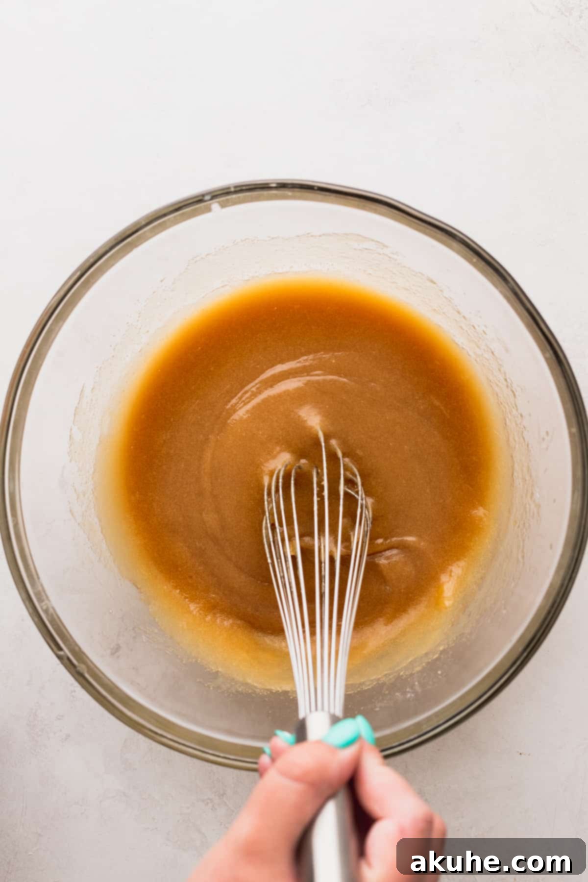 Fruity Pebbles Cookies 4 Close-up shot of the wet ingredients being mixed in a bowl, showcasing the smooth, creamy consistency.