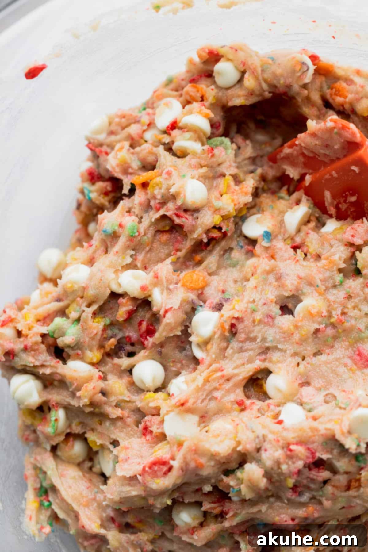 Fruity Pebbles Cookies 6 The cookie dough resting in a clear glass bowl, showcasing its soft texture before scooping.