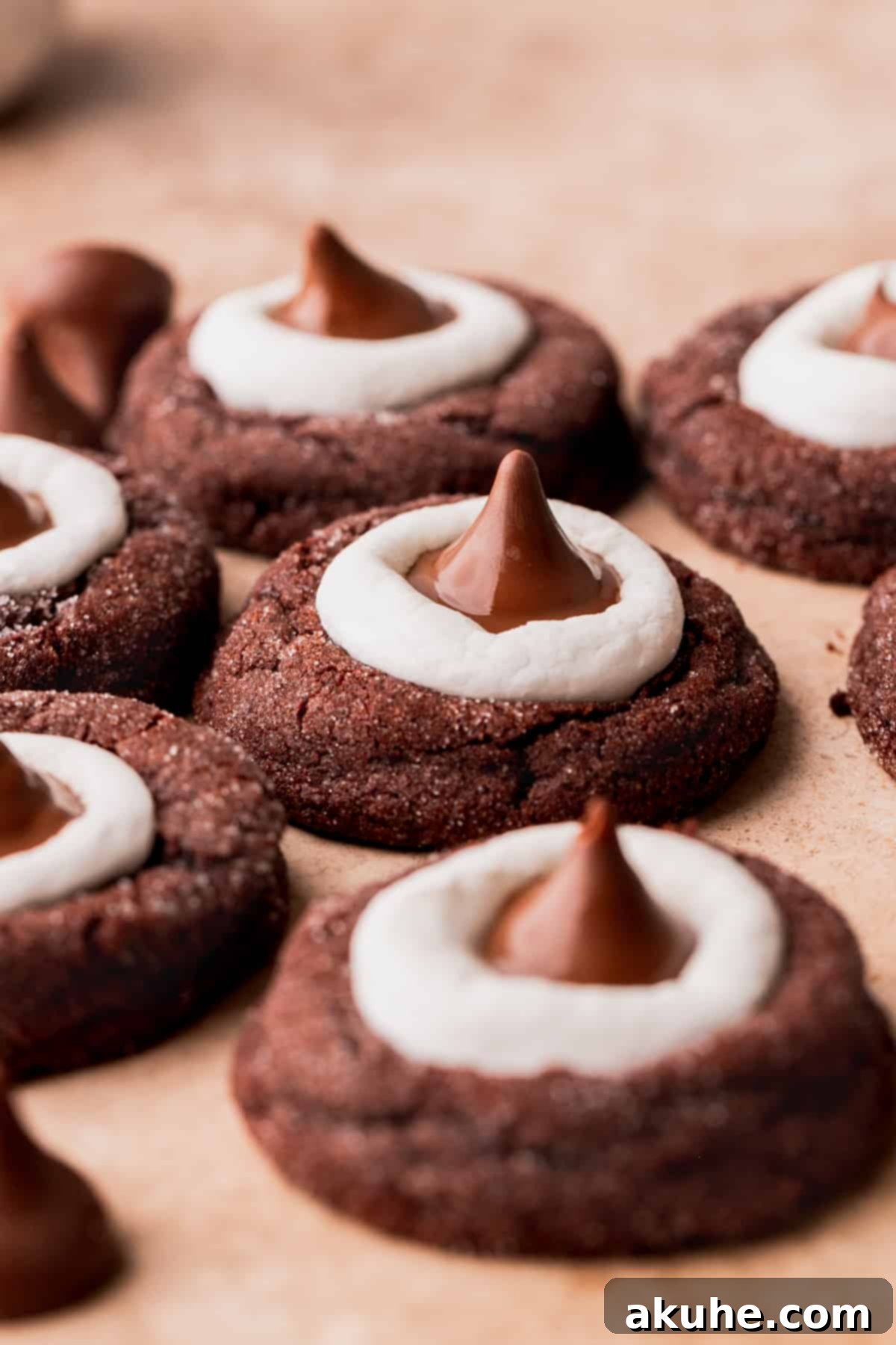 Warm Cocoa Blossom Cookies 2 Side view of a beautifully baked Hot Cocoa Cookie Blossom, showcasing its fudgy chocolate base, golden-brown melted marshmallow top, and a perfectly placed Hershey's Hot Cocoa Kiss.