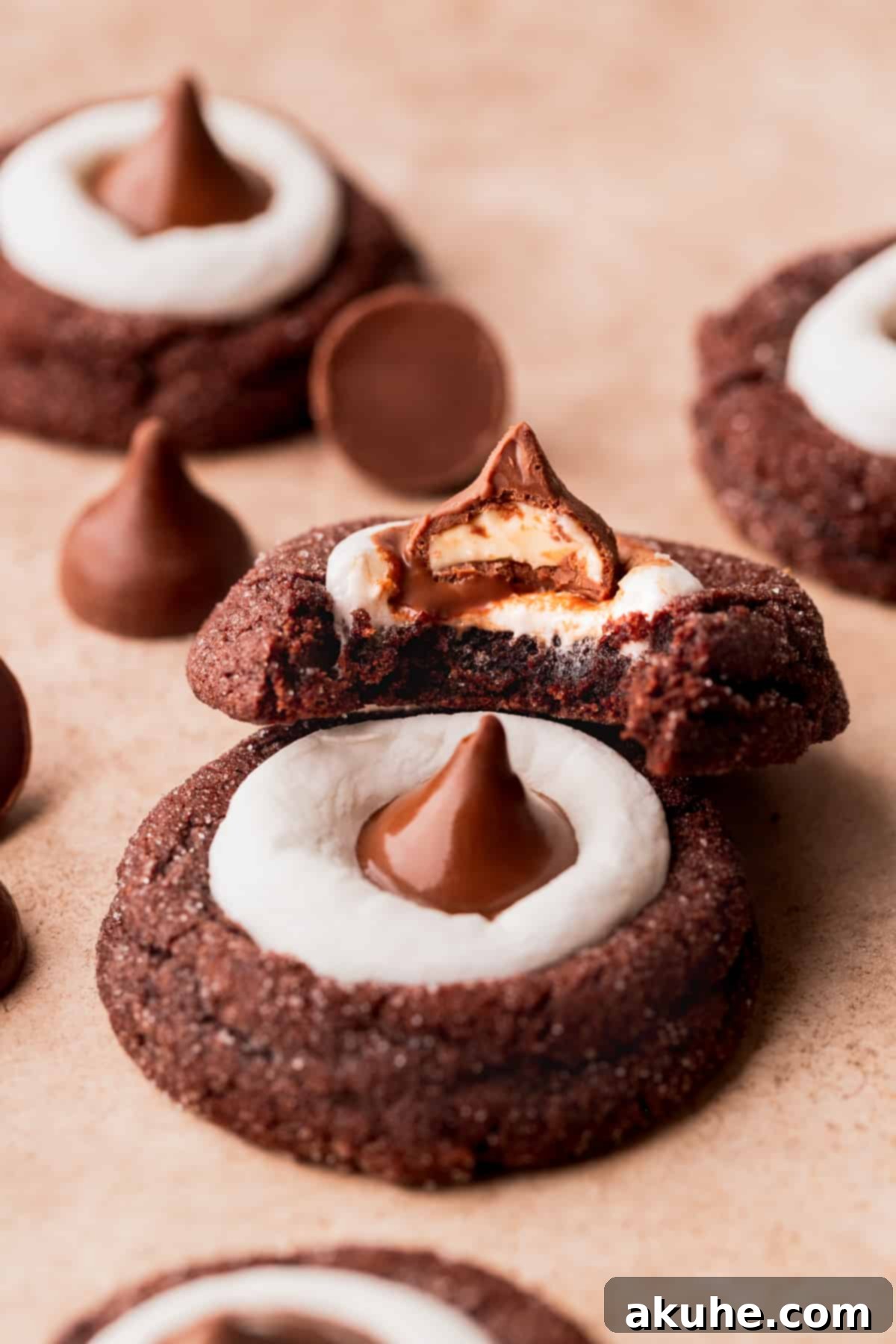Warm Cocoa Blossom Cookies 10 Close-up of a perfectly baked Hot Cocoa Cookie Blossom with a bite taken out, showing the fudgy chocolate interior, melted marshmallow, and Hershey's Kiss.