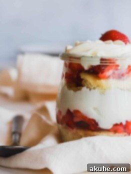 Effortless Strawberry Shortcake Delights 8 1 easy strawberry shortcake trifles in a jar on a flowing napkin.