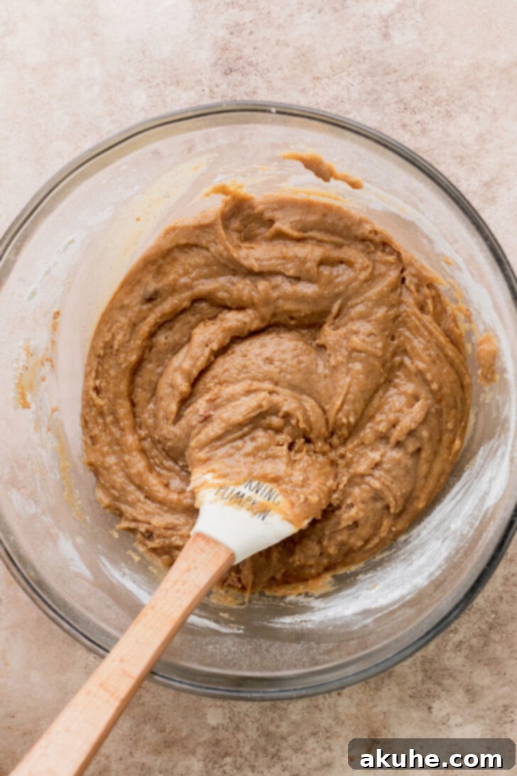 Smooth cookie dough in a bowl, showing perfect consistency after mixing dry ingredients.