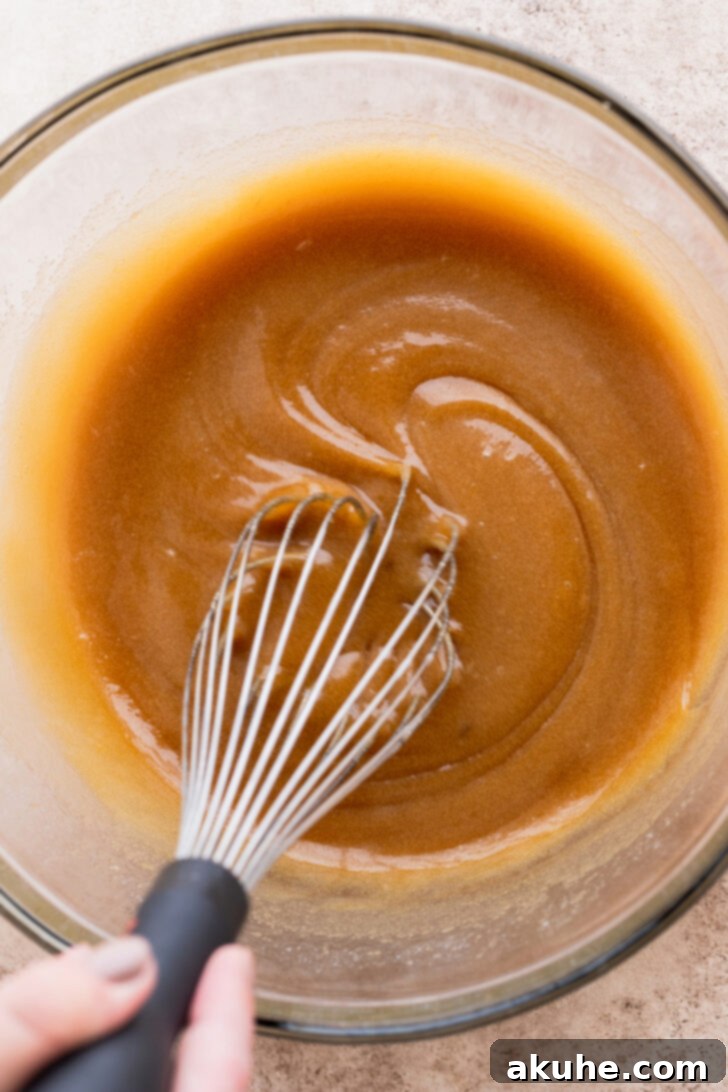 Spiced Apple Pie Cookies 6 Wet ingredients (melted butter, sugars, eggs, vanilla) mixed in a bowl.