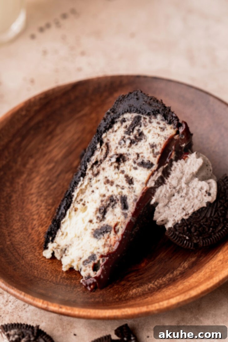 Ultimate Oreo Cheesecake 3 One slice of cheesecake on a plate.