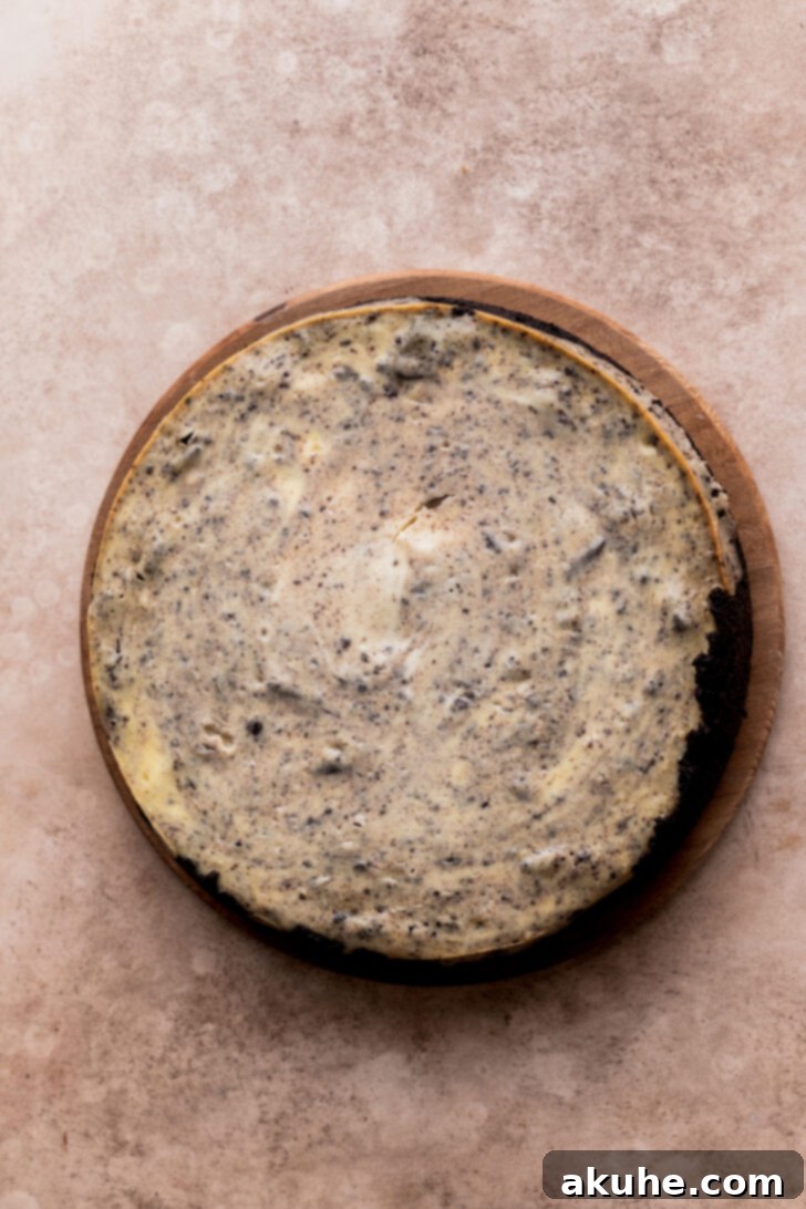 Ultimate Oreo Cheesecake 7 Baked cheesecake on a board.