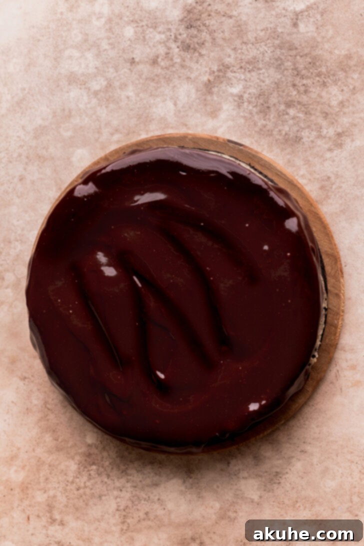 Ultimate Oreo Cheesecake 8 Chocolate ganache on top of cheesecake.