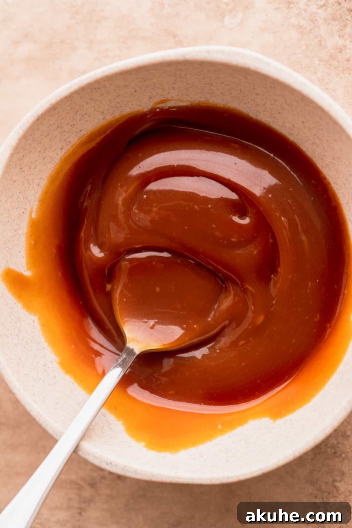 Decadent Caramel Cinnamon Rolls 8 Freshly made salted caramel in a bowl, showing its rich, glossy texture.