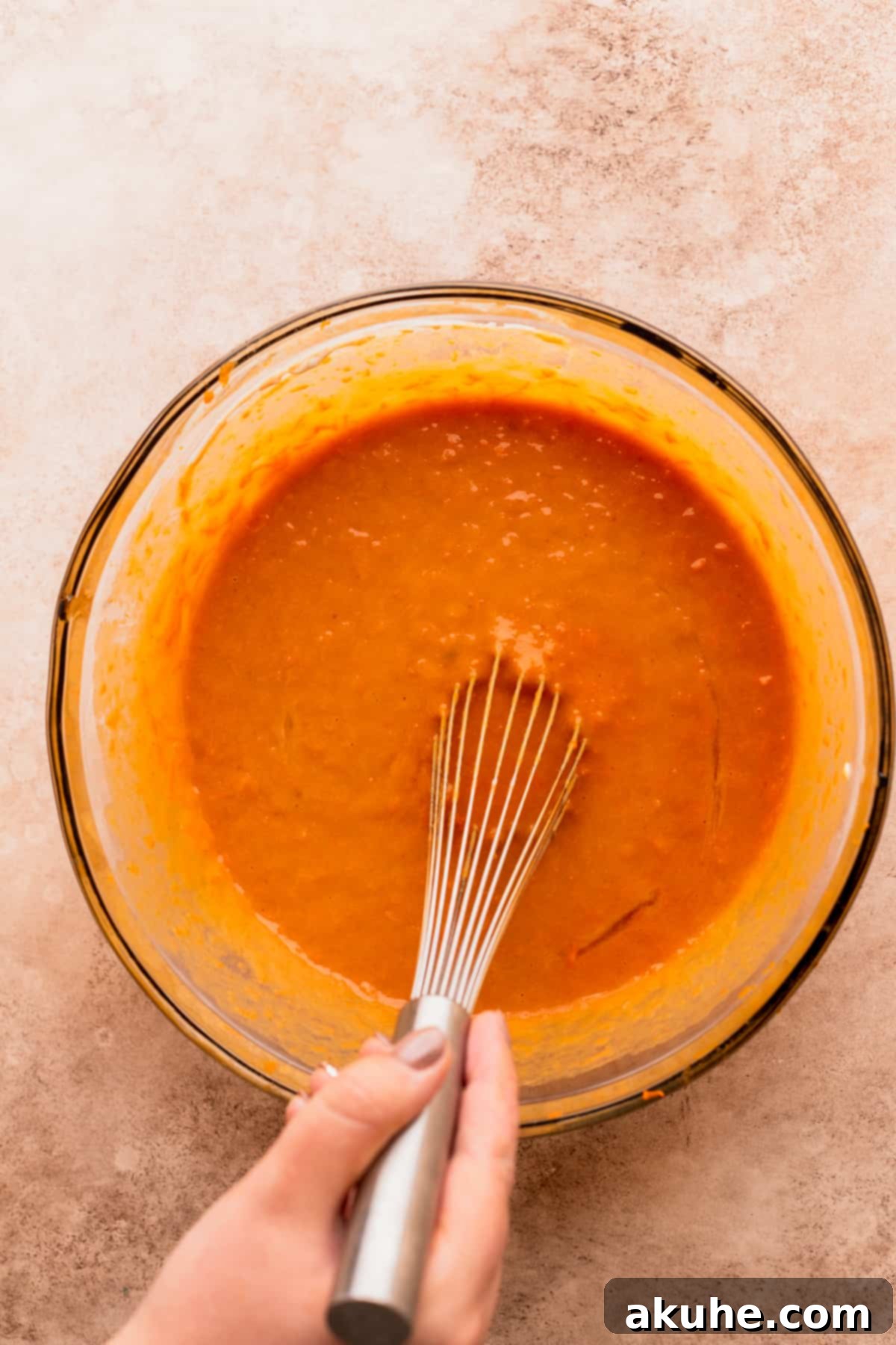 Wet ingredients perfectly mixed in a bowl, showcasing smooth consistency.