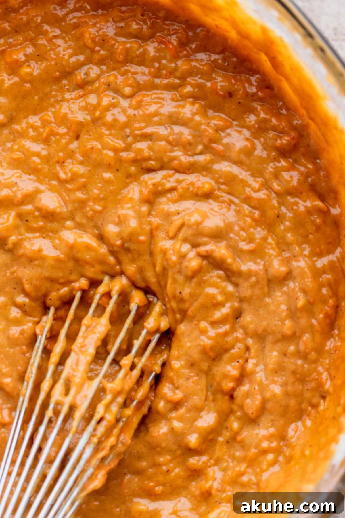 Smooth cake batter in a glass bowl, showcasing ideal texture before baking.
