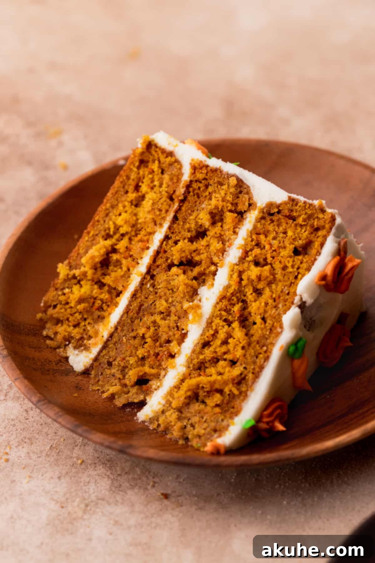 Single slice of pumpkin carrot cake on a white plate, beautifully presented.