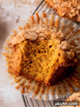 Autumn Spiced Banana Pumpkin Muffins 11 One bite missing from pumpkin banana muffins.