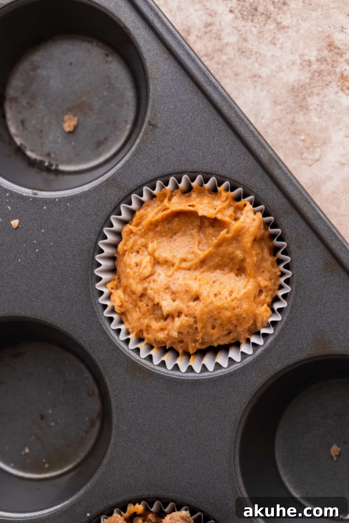 Autumn Spiced Banana Pumpkin Muffins 6 Muffin batter neatly scooped into a muffin pan.