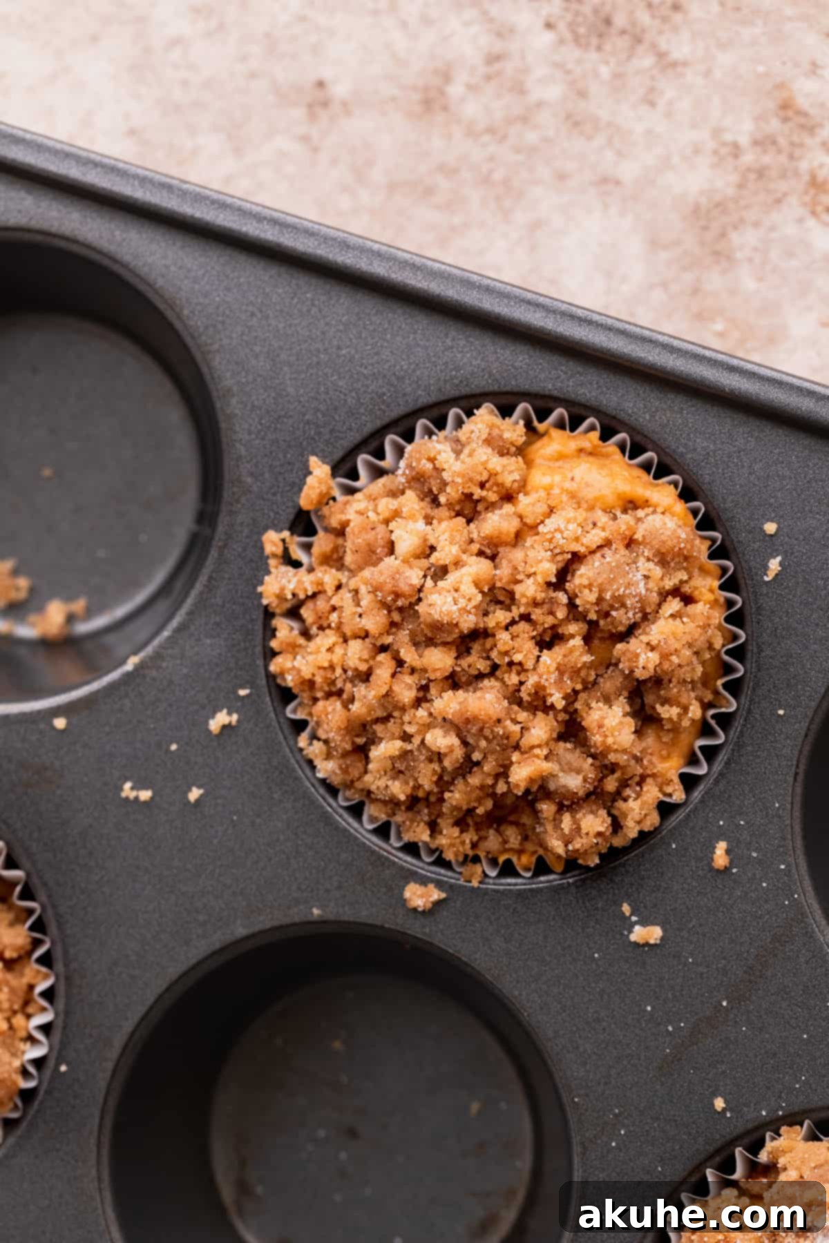 Autumn Spiced Banana Pumpkin Muffins 7 Streusel generously sprinkled on top of muffin batter.