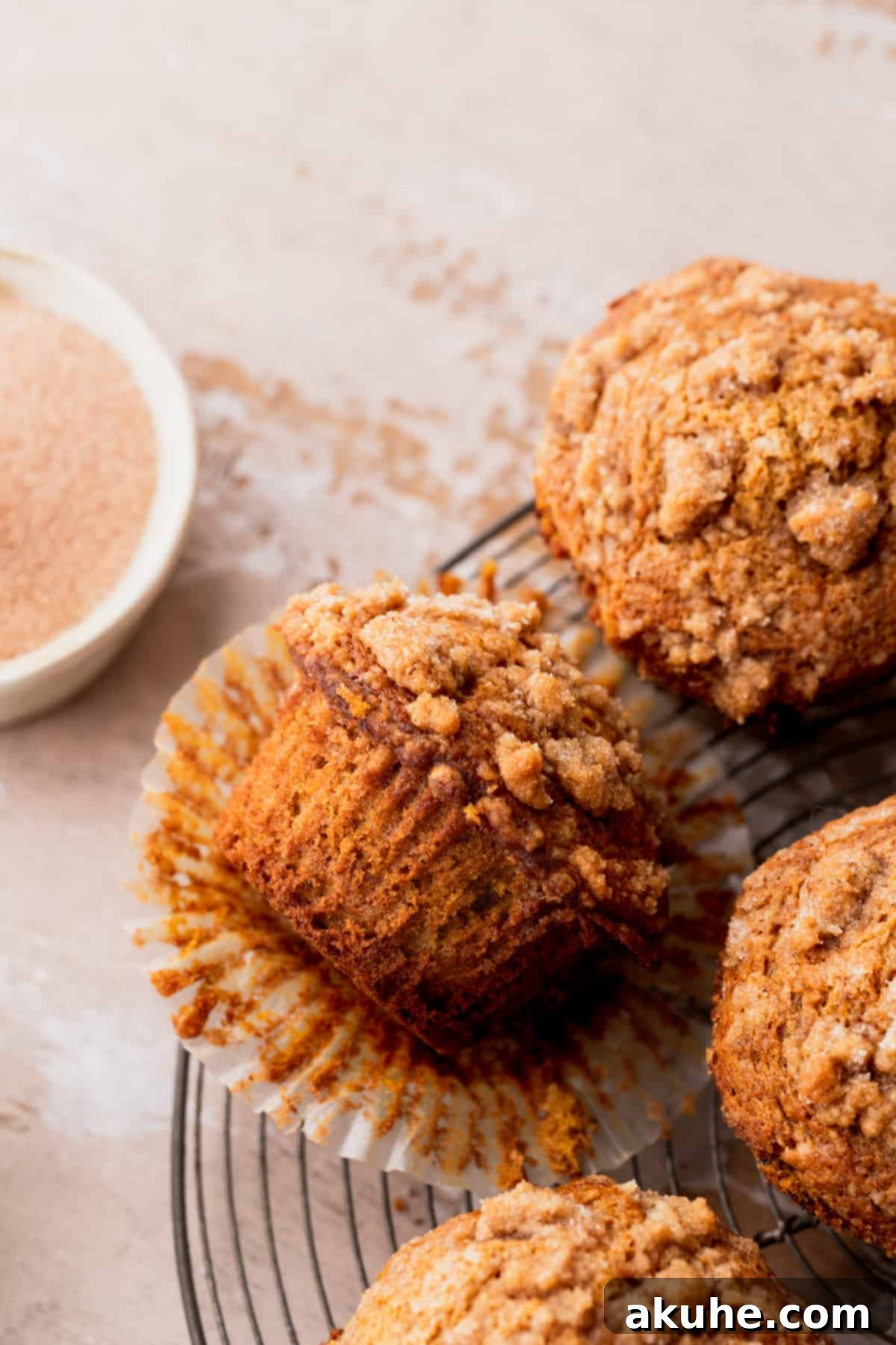 Autumn Spiced Banana Pumpkin Muffins 9 A freshly baked pumpkin banana muffin cut open, revealing its soft and moist interior.