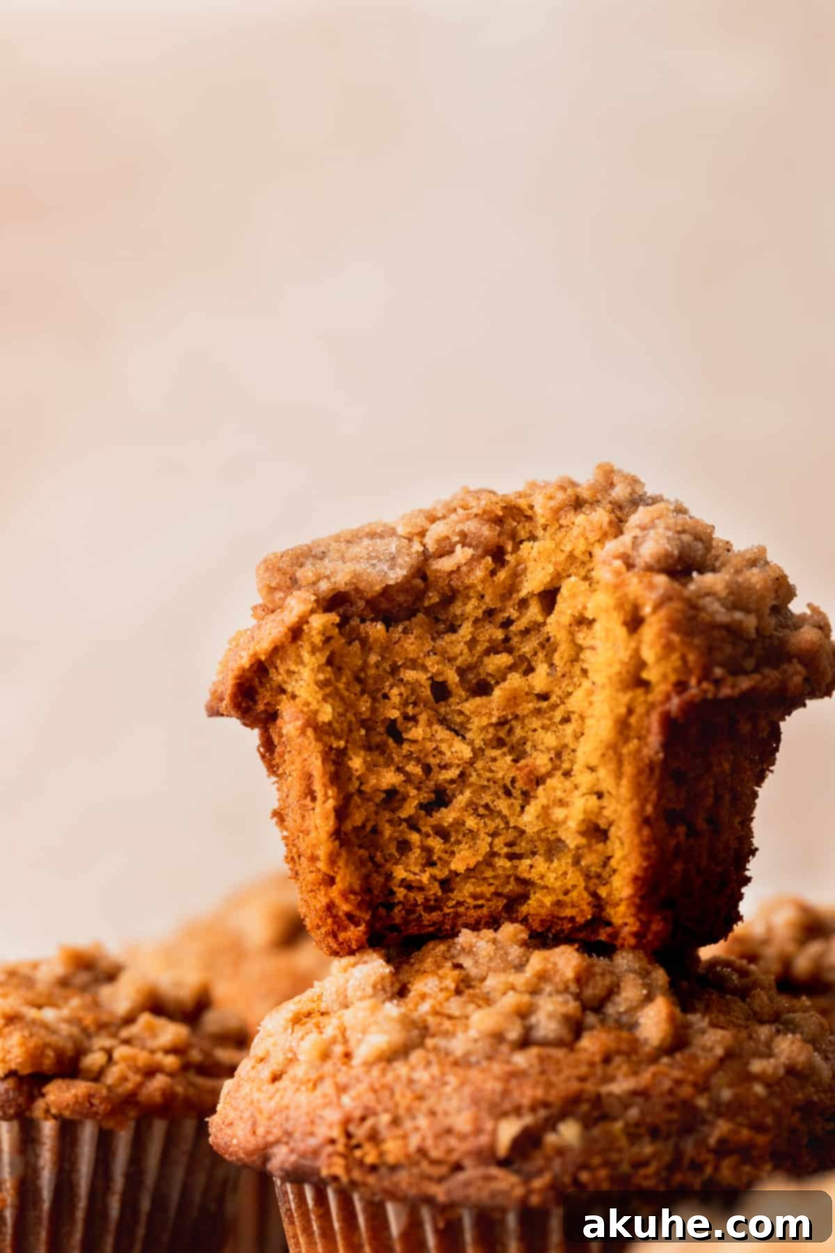 Autumn Spiced Banana Pumpkin Muffins 10 A close-up view of perfectly baked pumpkin banana muffins with streusel topping.