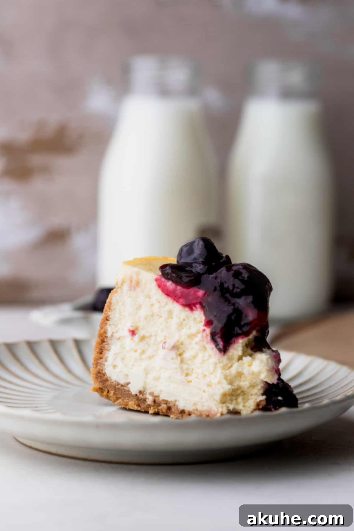 Mini Cheesecakes 14 One perfect cheesecake slice on a plate, ready to be enjoyed.
