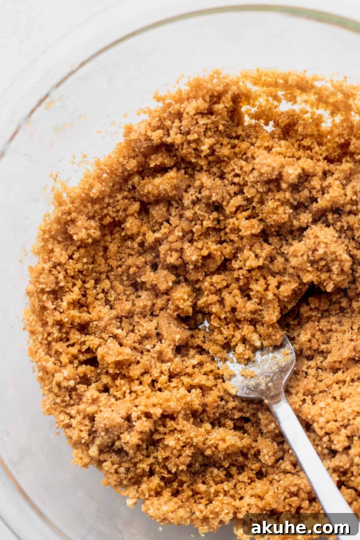 Mini Cheesecakes 4 Graham cracker crumbs in a glass bowl, ready for mixing.