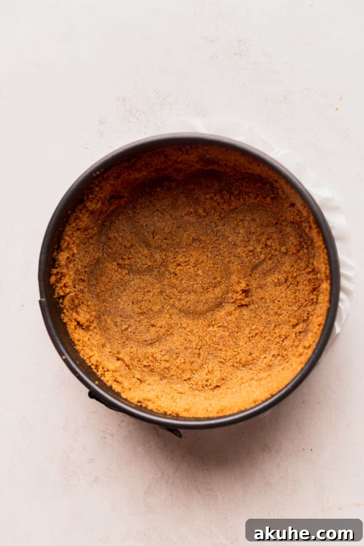 Mini Cheesecakes 5 Graham cracker crust compacted in a springform pan, ready for baking.