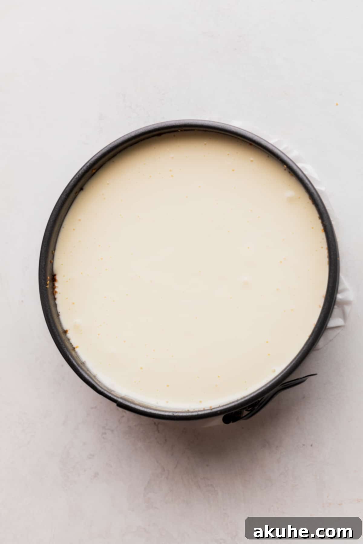 Mini Cheesecakes 8 Cheesecake batter poured into a springform pan on top of the crust.