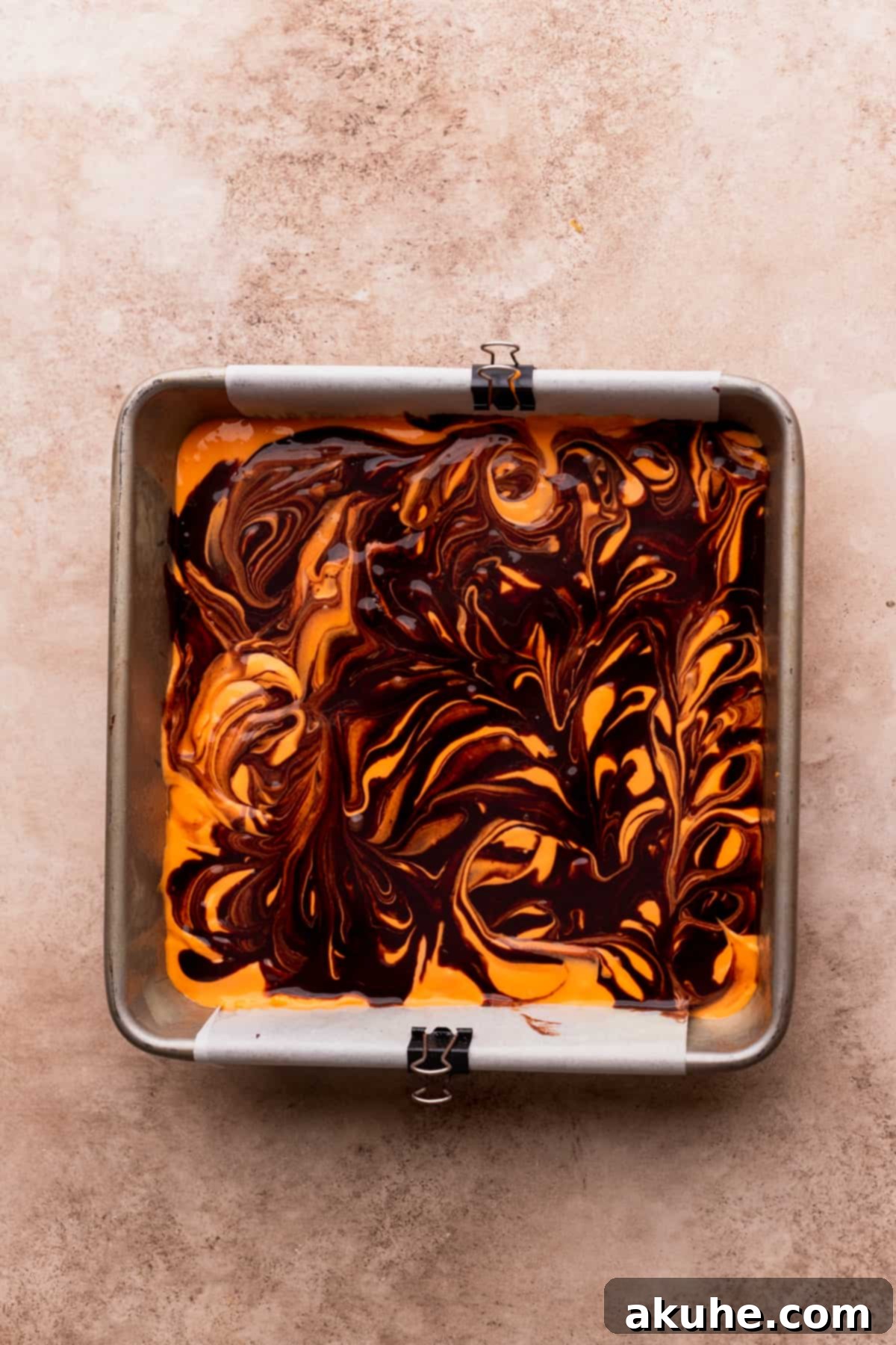 Beautifully swirled brownie and cheesecake batter in the pan, pre-baking.