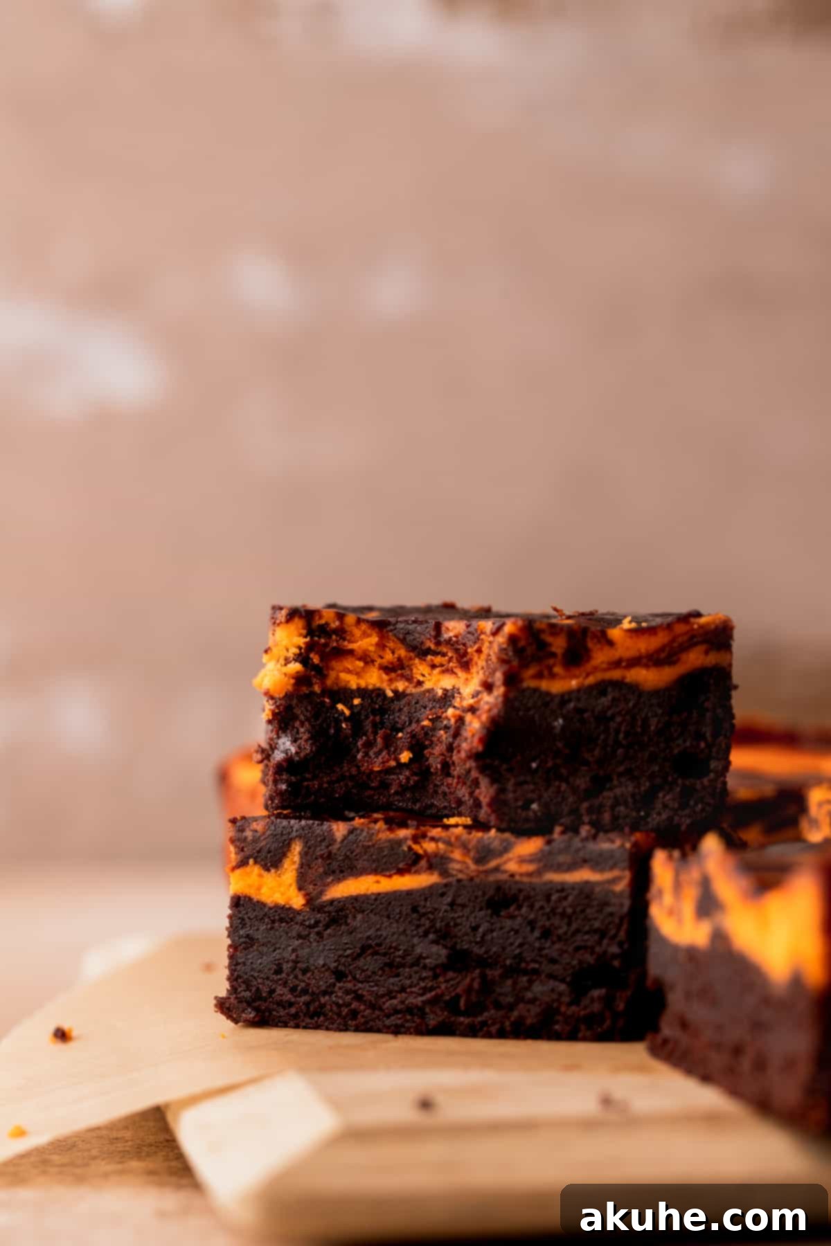 A stack of Halloween brownies, one with a bite taken out, showing the delicious interior.