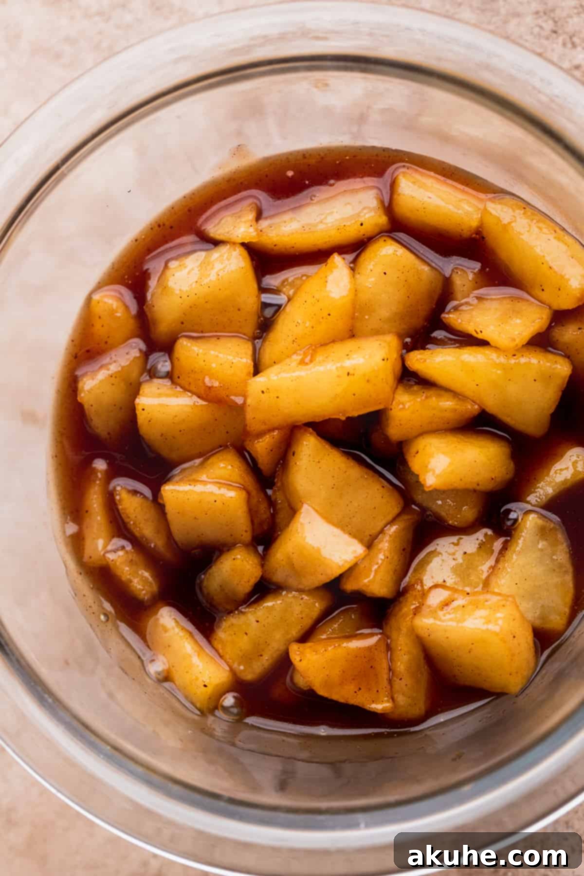 Ultimate Apple Crumble Cheesecake 10 A bowl filled with luscious, spiced apple pie filling, ready to be layered.